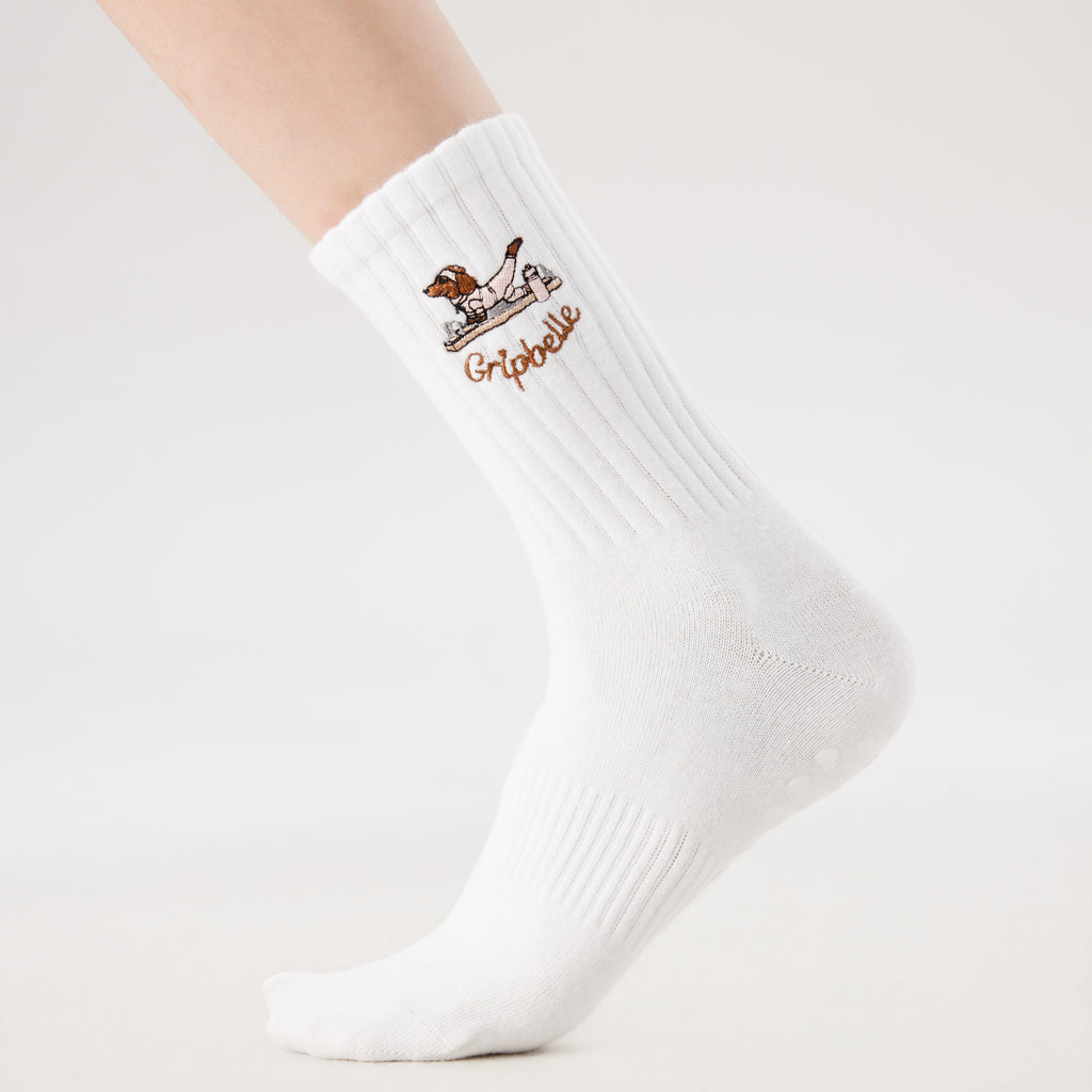 White Pilates grip socks with puppy embroidery and heart-shaped non-slip grips