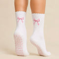 White Pilates grip socks with pink bow embroidery and heart-shaped non-slip grips for Reformer Pilates