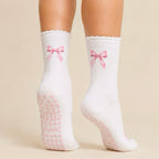 White Pilates grip socks with pink bow embroidery and heart-shaped non-slip grips for Reformer Pilates